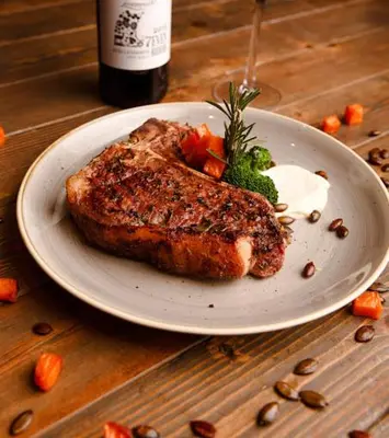 a plate of food with meat and vegetables on a table at 514 at The Regency in Pretoria