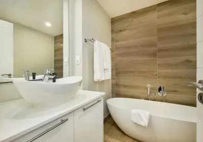a white bathroom with a tub and a sink and a bath tub at 514 at The Regency in Pretoria