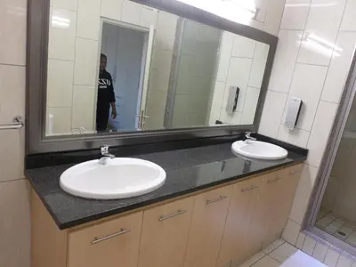 a bathroom with two sinks and a large mirror at The Links Guest House in Pretoria