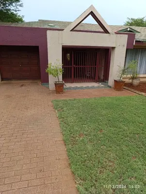 a house with a brick driveway and a garage at Studio S Class and Comfort in Pretoria
