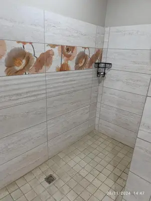 a bathroom with a walk in shower with wood paneling at Studio S Class and Comfort in Pretoria