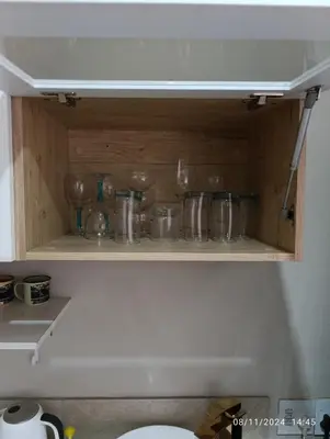 a cupboard with glasses and other items on it at Studio S Class and Comfort in Pretoria
