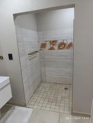 a bathroom with a shower with cows on the wall at Studio S Class and Comfort in Pretoria