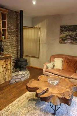 a living room with a couch and a coffee table at Matumi Trail Forest Lodges - Matumi and Mitzeeri in Tzaneen