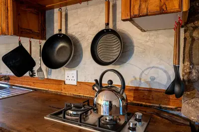 a tea kettle on a stove in a kitchen at Matumi Trail Forest Lodges - Matumi and Mitzeeri in Tzaneen