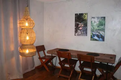 a dining room with a table and chairs and a lamp at Matumi Trail Forest Lodges - Matumi and Mitzeeri in Tzaneen