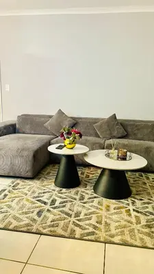 a living room with two tables in front of a couch at Bookings At The Blyde Crystal Lagoon in Pretoria