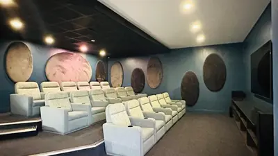 a room with white chairs and a wall with wooden barrels at Bookings At The Blyde Crystal Lagoon in Pretoria