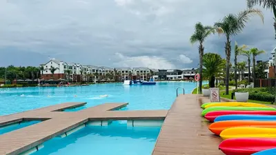 a large swimming pool with colorful inflatables in a resort at Bookings At The Blyde Crystal Lagoon in Pretoria