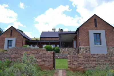a brick house with a brick wall at 22 on Ridgeway in Dullstroom