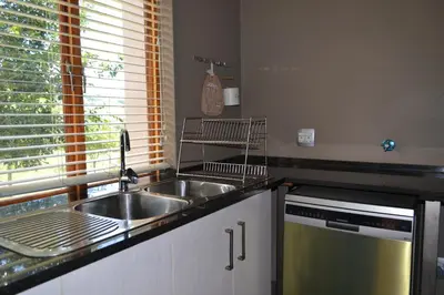 a kitchen with a sink and a dishwasher at 22 on Ridgeway in Dullstroom