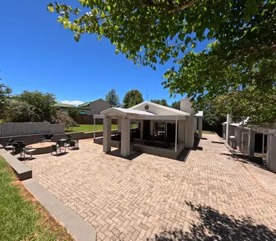 a pavilion with a table and chairs on a patio at Spindermolen in Dullstroom