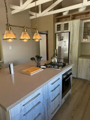 a kitchen with a counter with a stove top oven at Spindermolen in Dullstroom
