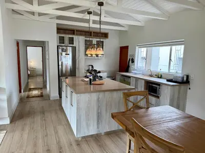 a kitchen with a wooden counter top and a table at Spindermolen in Dullstroom