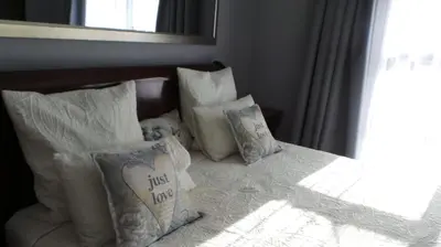 a group of pillows sitting on top of a bed at Amatolo view in Erasmus