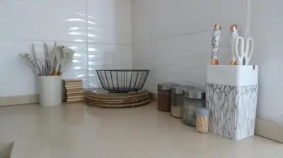 a kitchen counter with utensils in a container on the floor at Amatolo view in Erasmus