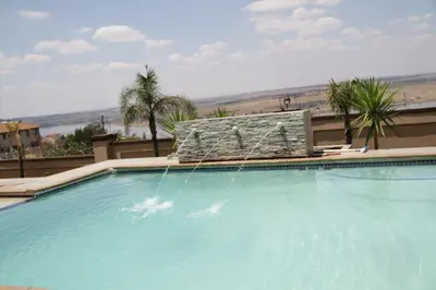 a large swimming pool with a water fountain at Amatolo view in Erasmus