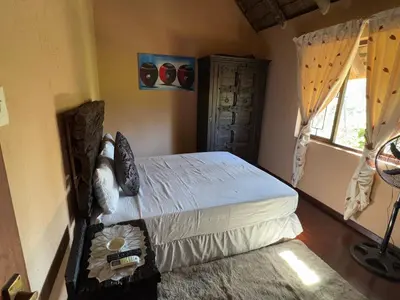 a bedroom with a bed and a window at VM Guesthouse in Hazyview