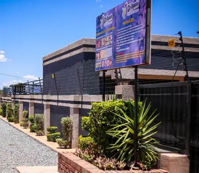 a street sign in front of a building at Dingwako Lodge in Mokopane