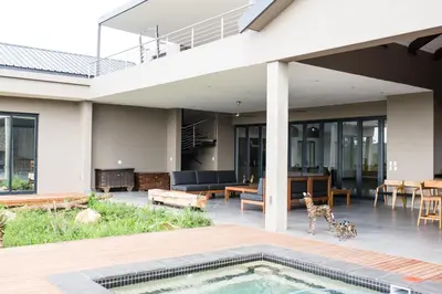 an external view of a house with a swimming pool at Ziziphus River Lodge in Hectorspruit