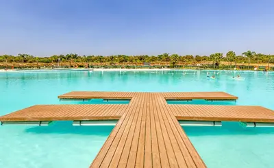 a wooden boardwalk in the middle of a lake at The Blyde Paradise Luxury 1 Bed in Pretoria
