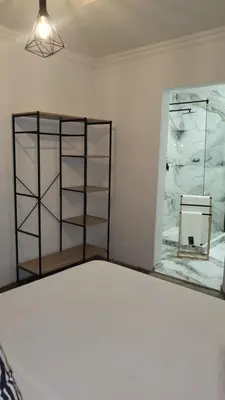 a room with a shelf and a mirror at Villa Tlhago Lodge in Ga-Mothapo
