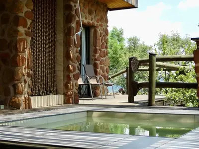 a swimming pool on the deck of a house at Forestiva Farm - Mountain Retreat in Centurion