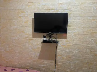 a flat screen tv on a wall at Cardinal Guest House in Pretoria