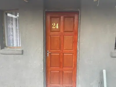 a red door with the number on it at Cardinal Guest House in Pretoria
