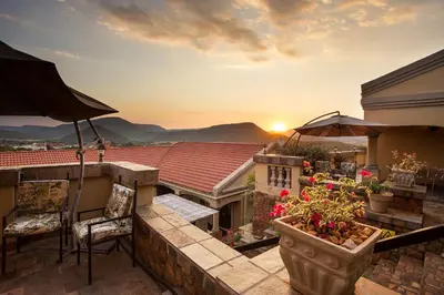 a balcony with a view of the sunset at The Royal Palm B&B in Ohrigstad