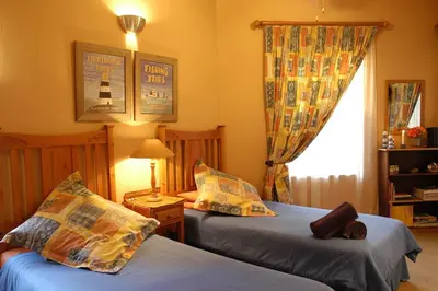 a bedroom with two beds and a window at Elonda B&B in Pretoria