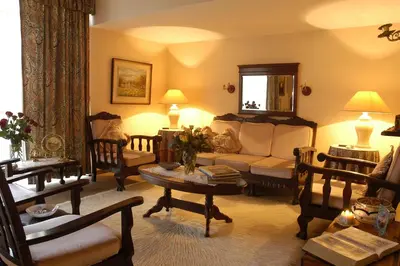 a living room with a couch and chairs at Elonda B&B in Pretoria