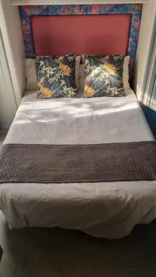 a large bed with two pillows on top of it at Harties Is Africa Safari Lodge in Hartbeespoort