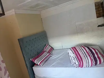 a bed with two pillows on it in a room at Cardinal Guest House in Pretoria