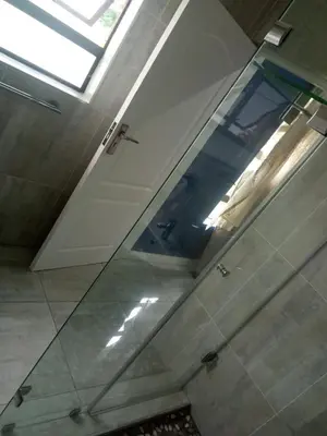 a glass floor in a bathroom with a skylight at BudiasGuest B&B in Kempton Park