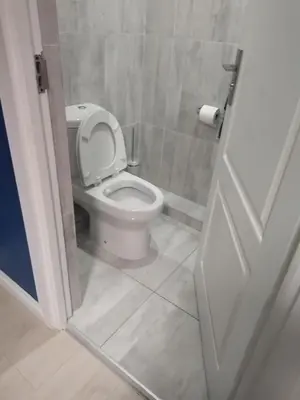 a bathroom with a white toilet in a stall at BudiasGuest B&B in Kempton Park