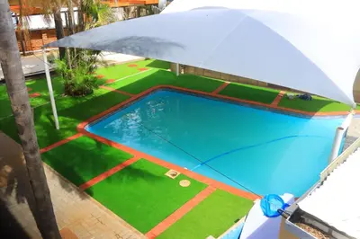 an overhead view of a pool with an umbrella at Musina Crown Guest House in Musina