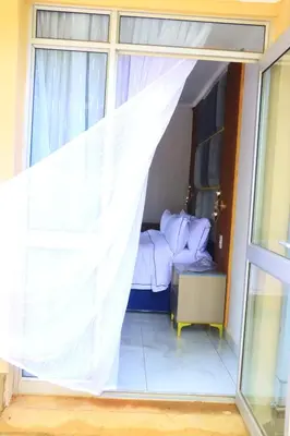 a bedroom with a bed and a window with a curtain at Musina Crown Guest House in Musina