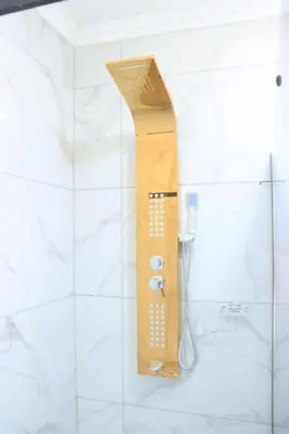 a shower in a bathroom with a wooden shower head at Musina Crown Guest House in Musina