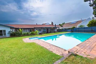 a swimming pool in the yard of a house at House 22 on Alice in Centurion