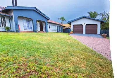 a house with a garage and a grass yard at House 22 on Alice in Centurion