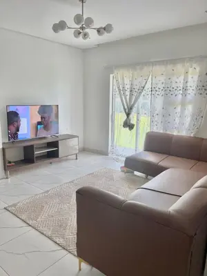 a living room with a couch and a flat screen tv at Mphoentle residence in Midrand