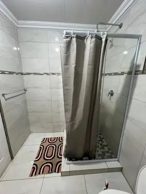 a shower with a shower curtain in a bathroom at The Ripanga Nest in Nelspruit