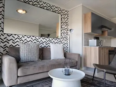 a living room with a couch and a table at Greencreek Lifestyle in Pretoria