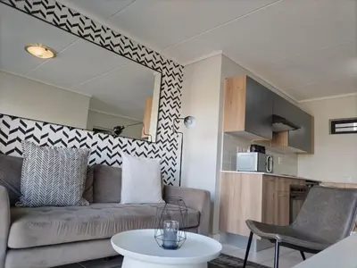 a living room with a couch and a table at Greencreek Lifestyle in Pretoria