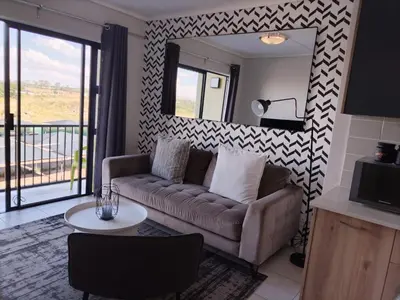 a living room with a couch and a mirror at Greencreek Lifestyle in Pretoria