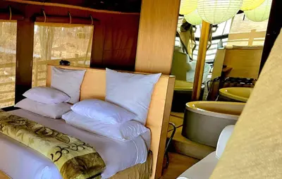 a bed with white pillows on top of a room at Thulani in Doornfontein