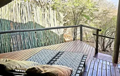 two pillows on a wooden deck with a fence at Thulani in Doornfontein