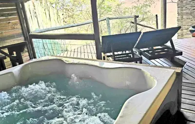 a bath tub filled with water on a deck at Thulani in Doornfontein