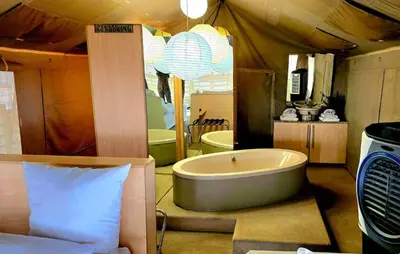 a large bathroom with a tub in a tent at Thulani in Doornfontein
